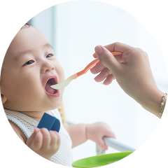 あかちゃんに朝ごはんを食べさせる様子